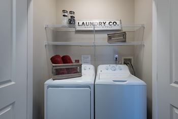 A Laundry Room With Two Washing Machines at The Aster Apartments, Cary, 27519